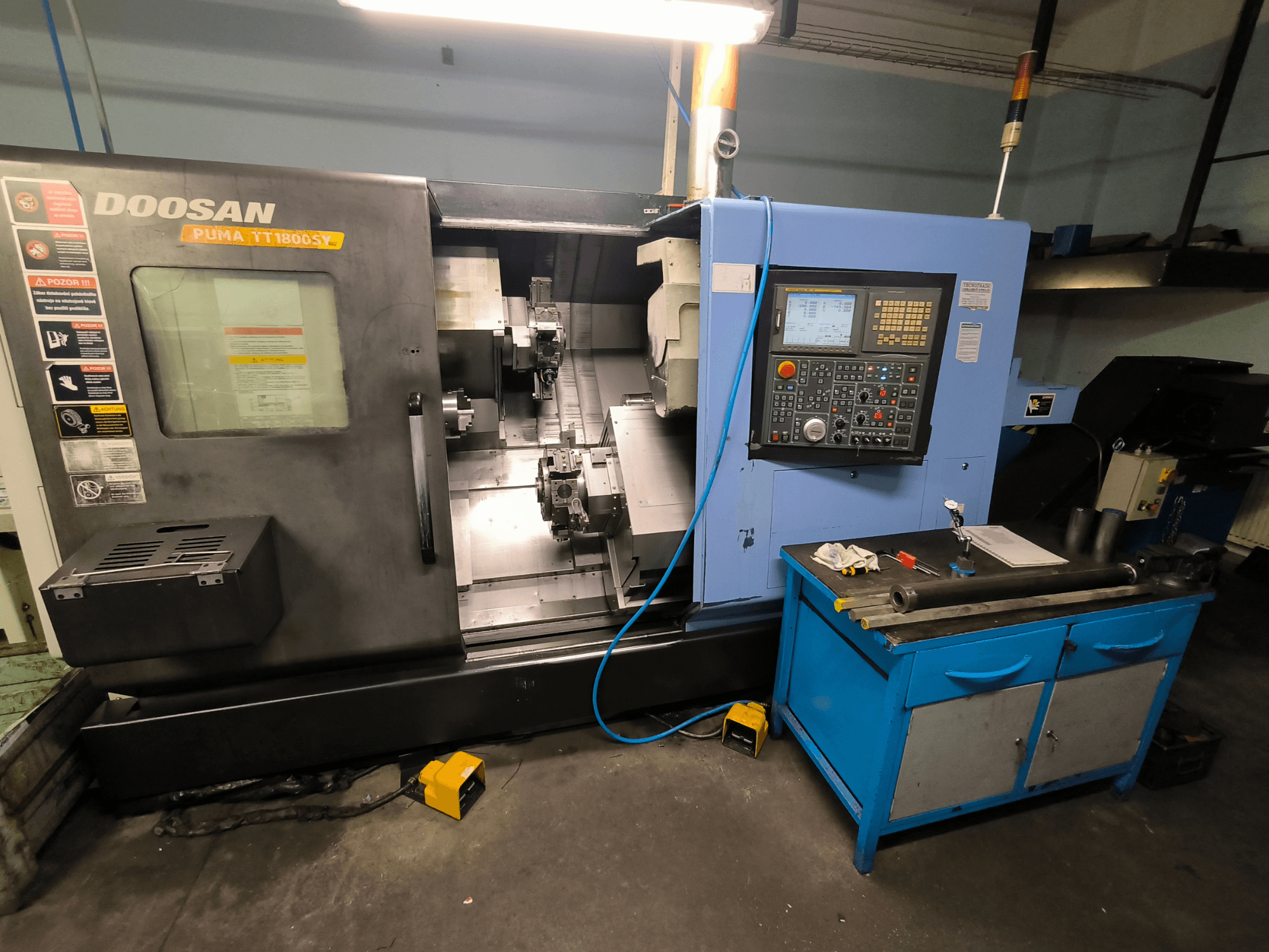 Doosan Puma TT1800SY CNC lathe, front view, showing control panel, work area with tools, and machine components.