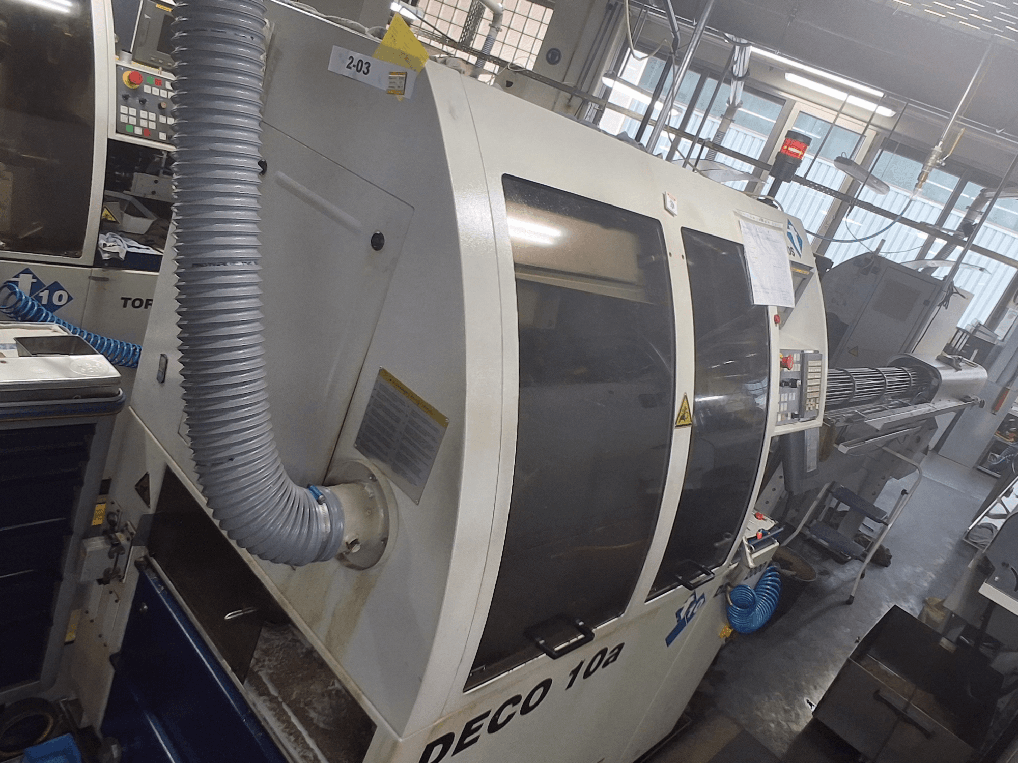 DECO 10a Maschine in der Frontansicht; großes Bedienfeld, Leitungen und Betriebsaufkleber sichtbar.