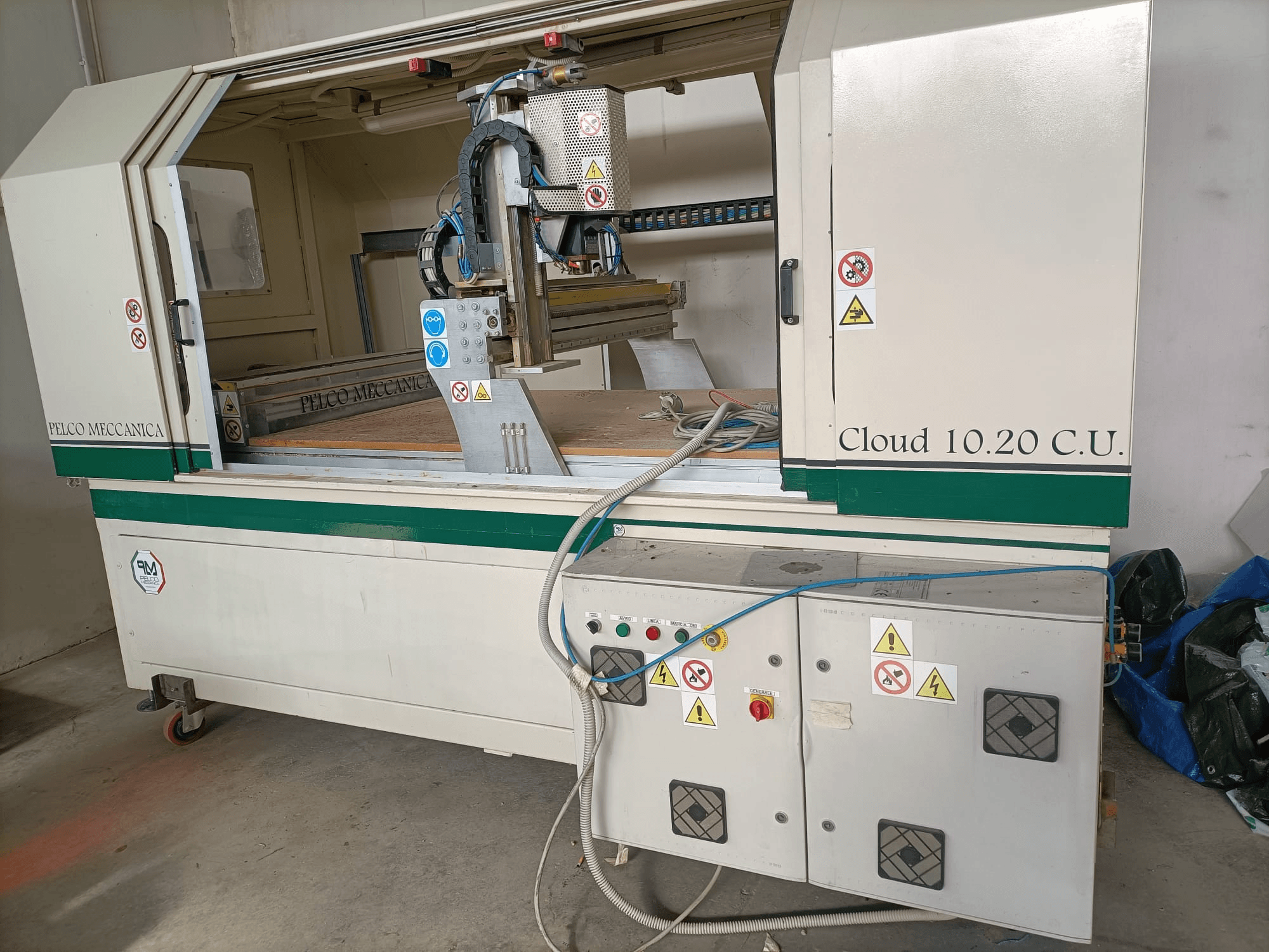 CNC-Fräsmaschine MECCANICA CLOUD 10.20 C.U., Vorderansicht mit Bedienfeld und Arbeitsbereich, Sicherheitsaufkleber und Schläuche sichtbar.