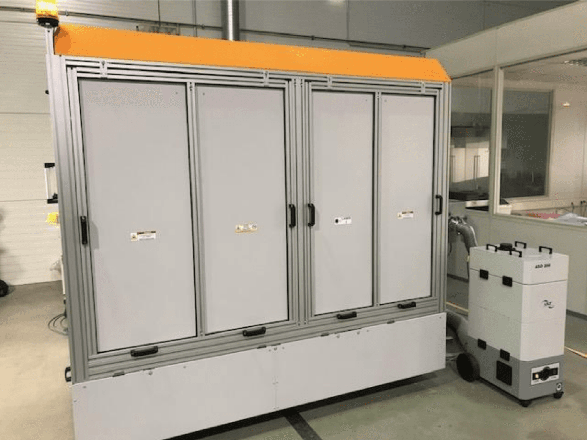 4JET Pearl M Faserlaserschneidmaschine, Vorderansicht, mit Sicherheitsleuchte, Bedienfeld und angeschlossener Absaugung sichtbar.