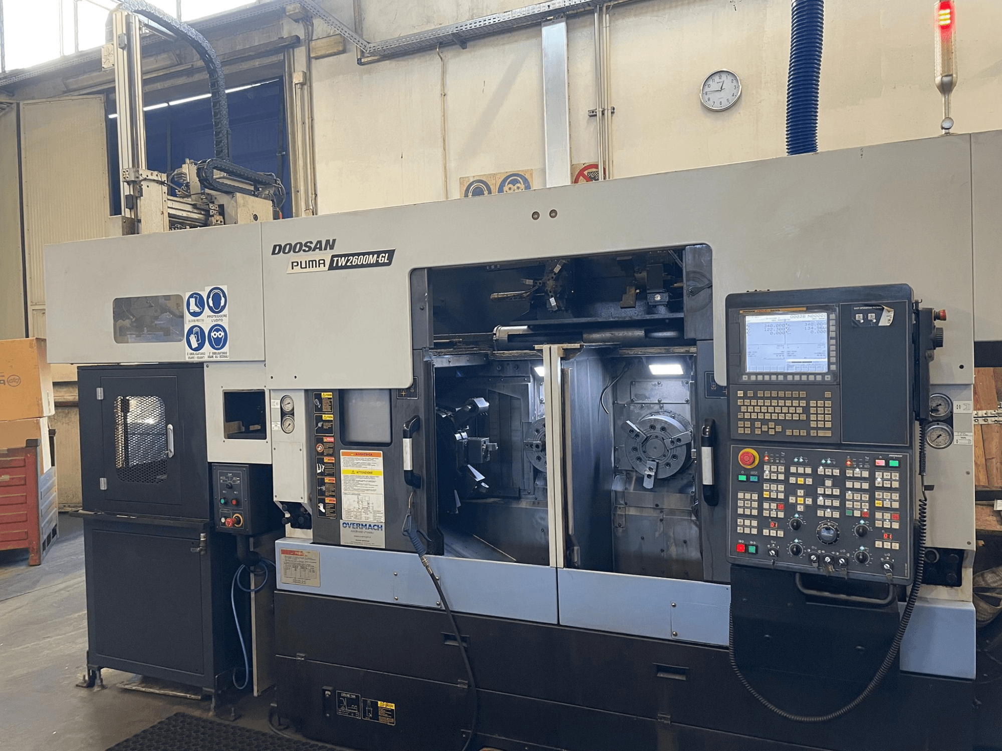 Doosan Puma TW2600M GL CNC lathe, front view, showcasing digital control panel and machine interior with tool holders.