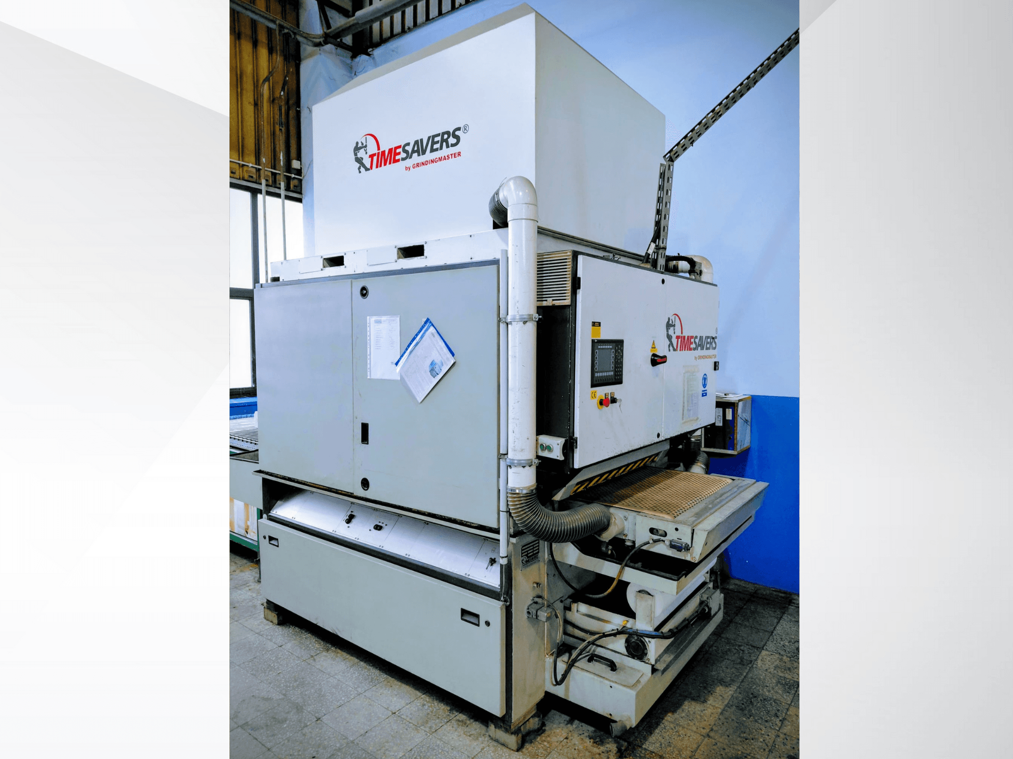 Timesavers industrial sander, front view. Features operational controls, dust extraction, and adjustable sanding bed for precision.