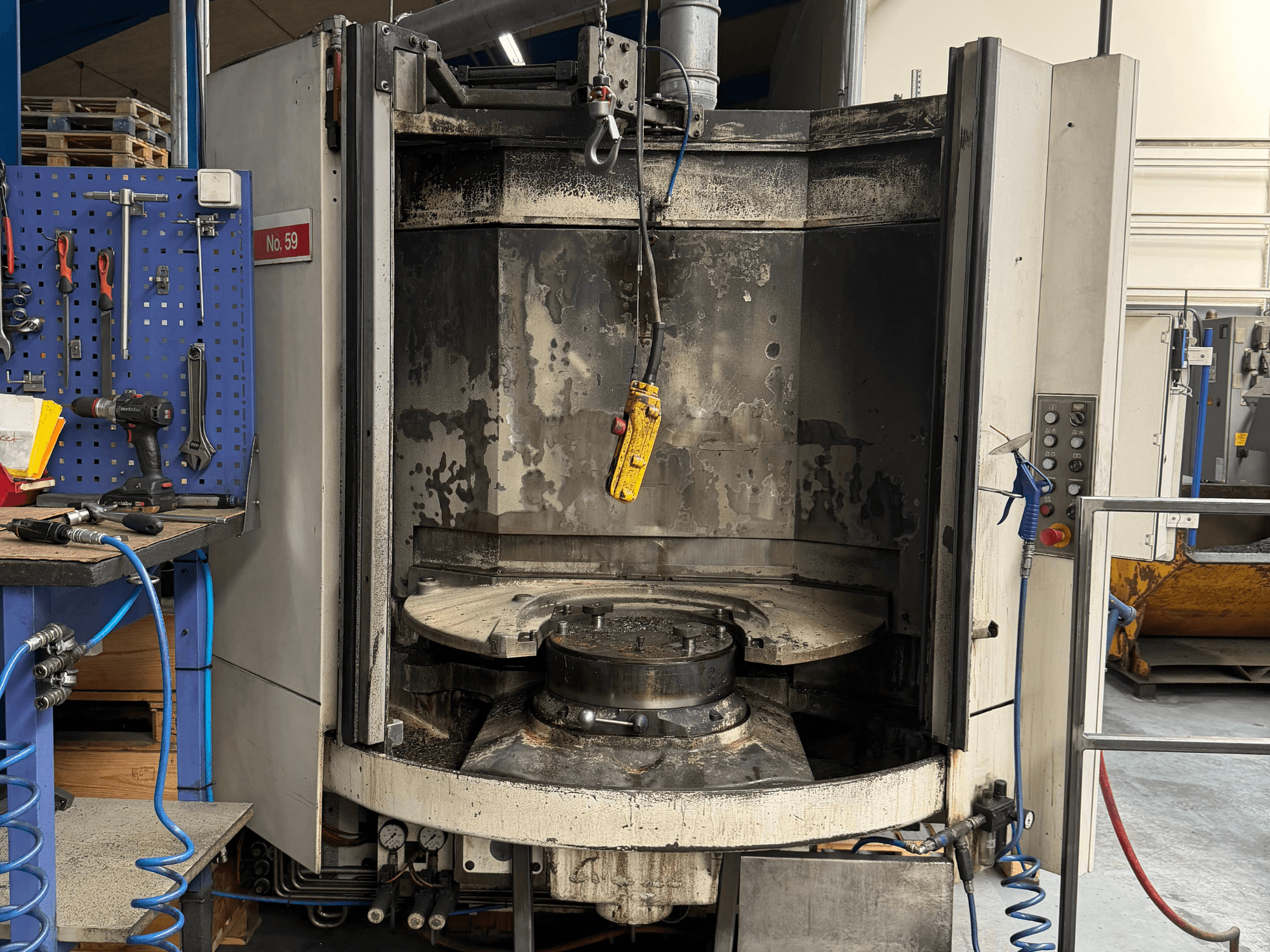 Horizontales Bearbeitungszentrum HELLER MC 16 in der Frontansicht mit leerem Arbeitstisch und Bedienfeld in einer Werkstatt.