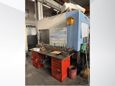 Doosan-Bearbeitungszentrum mit roter Werkbank und Stauraum für Werkzeuge und Ausrüstung, von vorne gesehen.