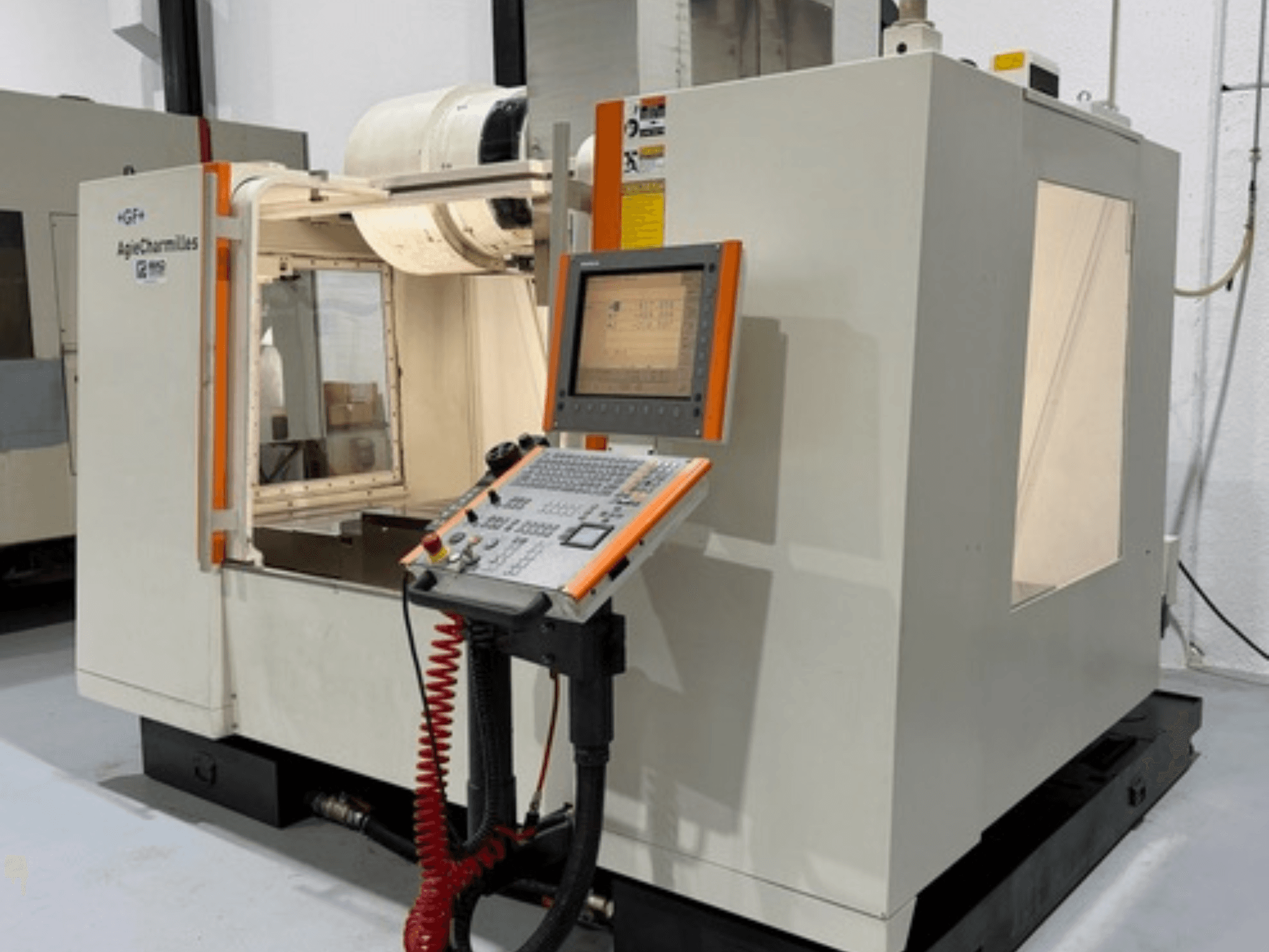 GF AgieCharmilles MIKRON milling machine in side view, featuring a control panel with buttons and a display screen.