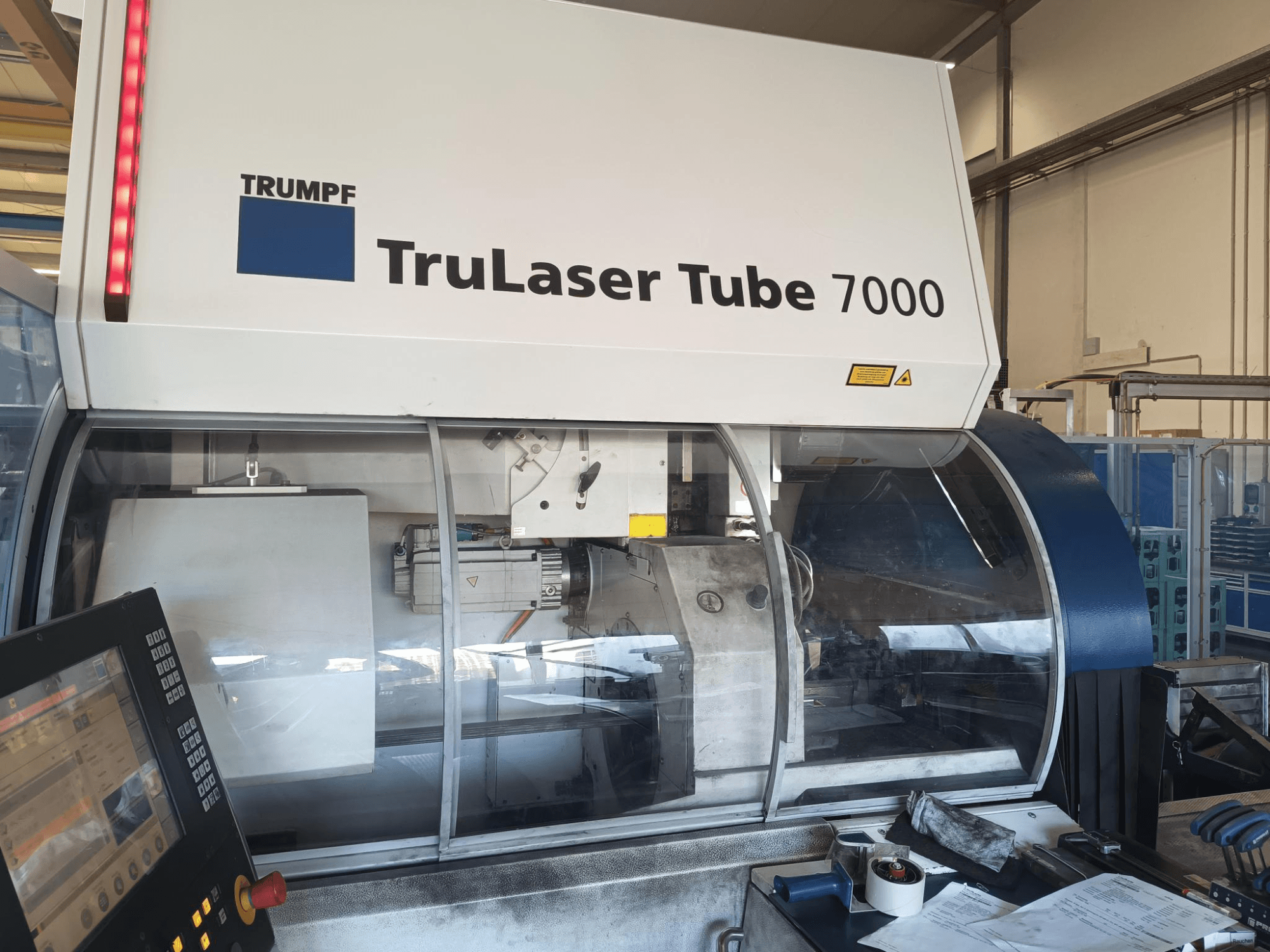 TRUMPF TruLaser Tube 7000, front view of machine with control panel, showcasing laser cutting features and workspace.