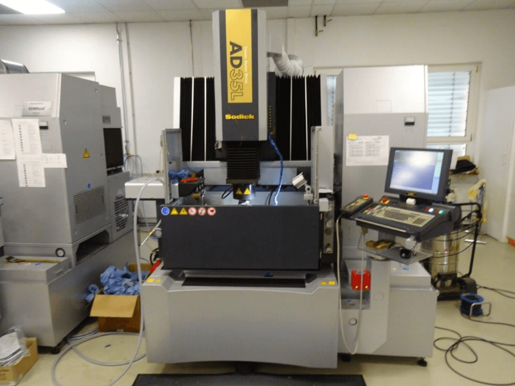 Sodick AD35L electrical discharge machine, front view with control panel, cooling system, and work area visible.