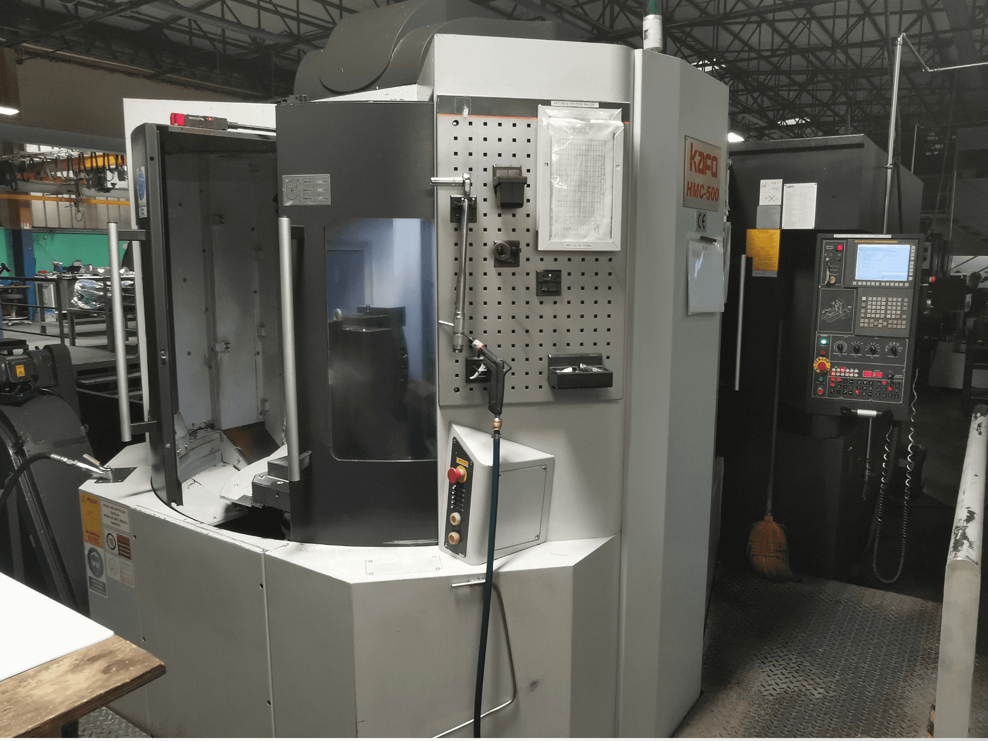 Kafo HMC-500 horizontal machining center, front view, showcasing control panel, tool holder, and empty machine chamber.