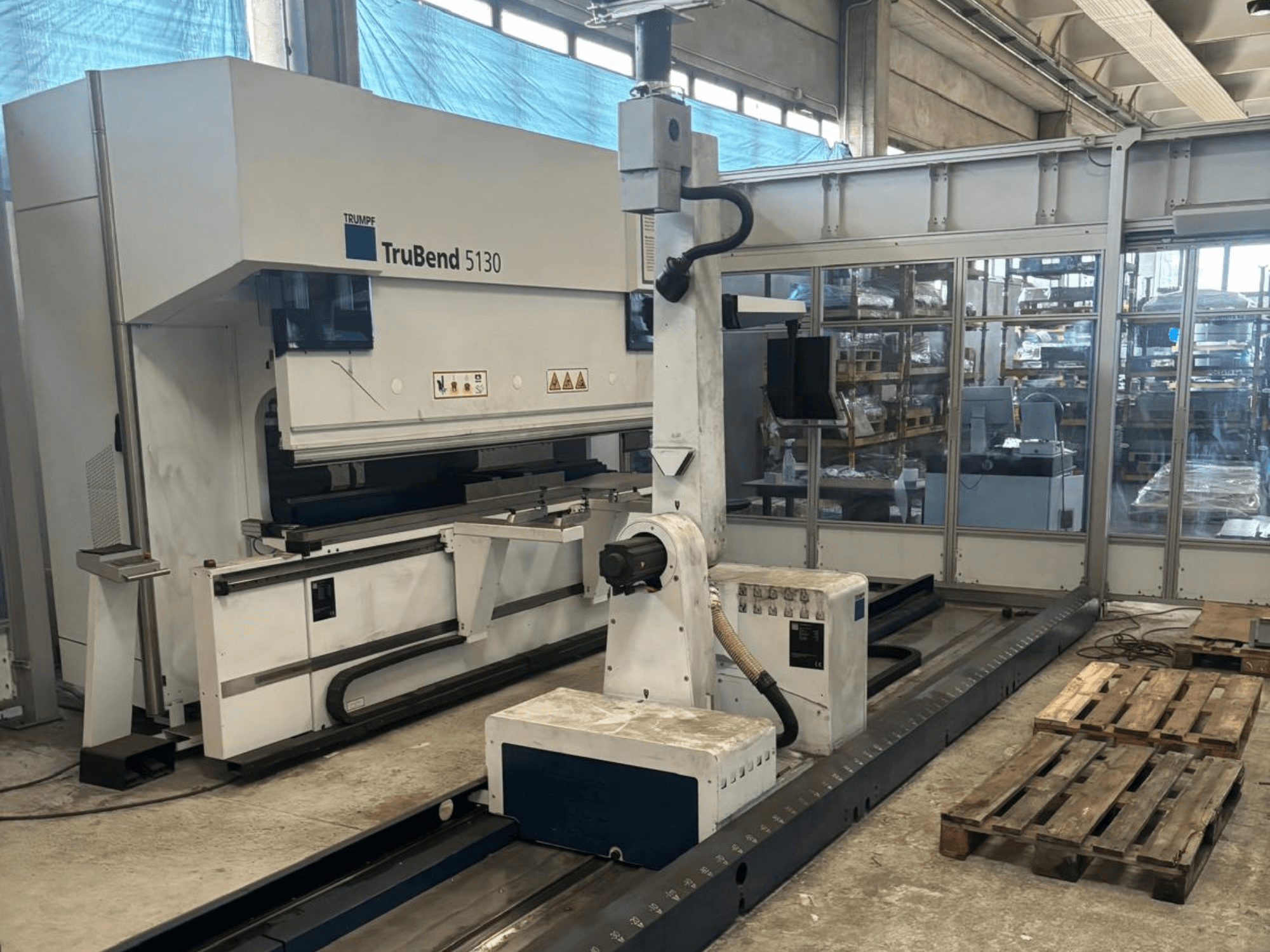 TruBend 5130 bending machine by Trumpf, front view, with control panel and pallets in a factory setting.