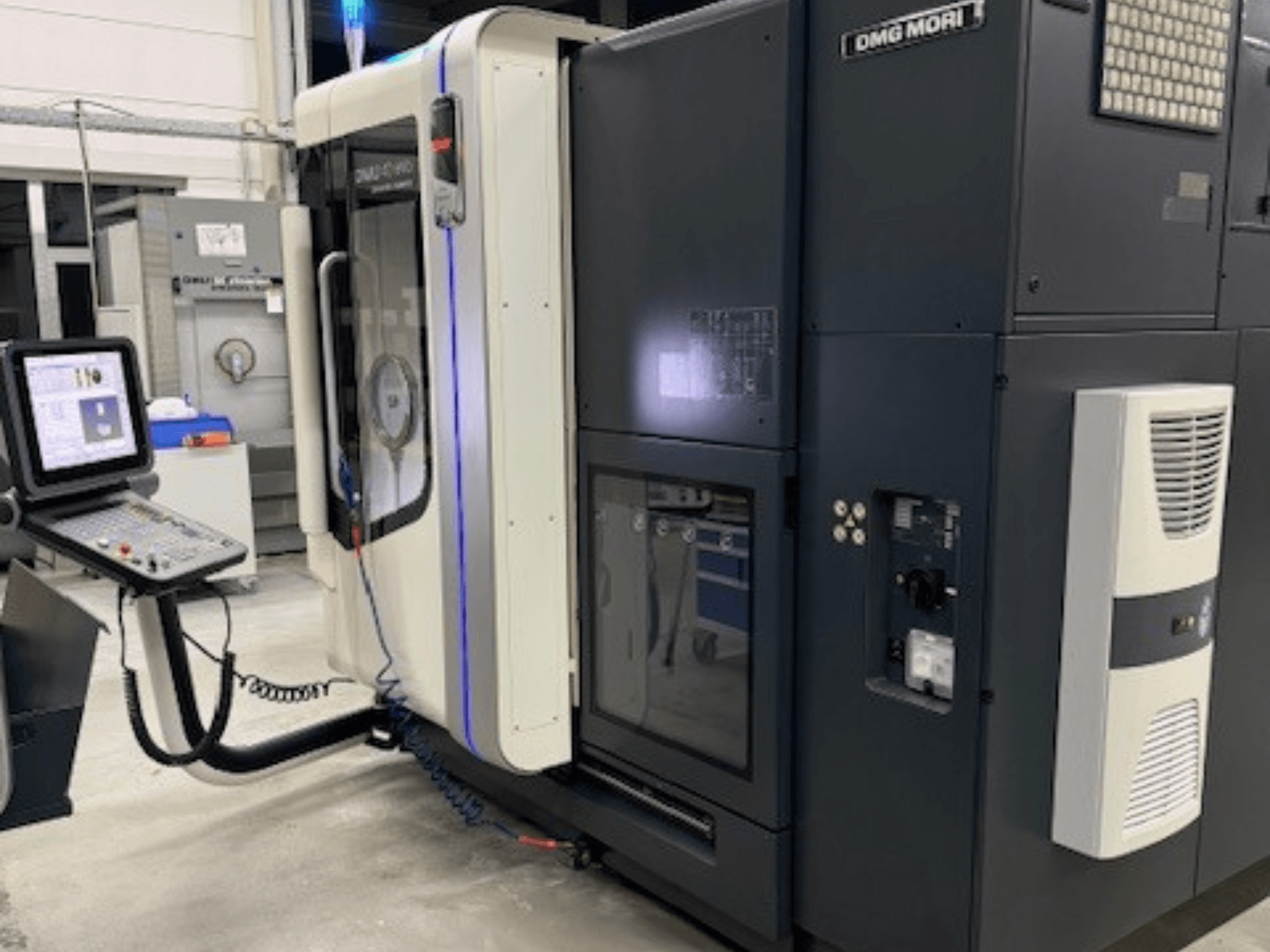 DMG MORI CNC machine, front view, featuring control panel, display, and cooling vent, ideal for precision machining tasks.