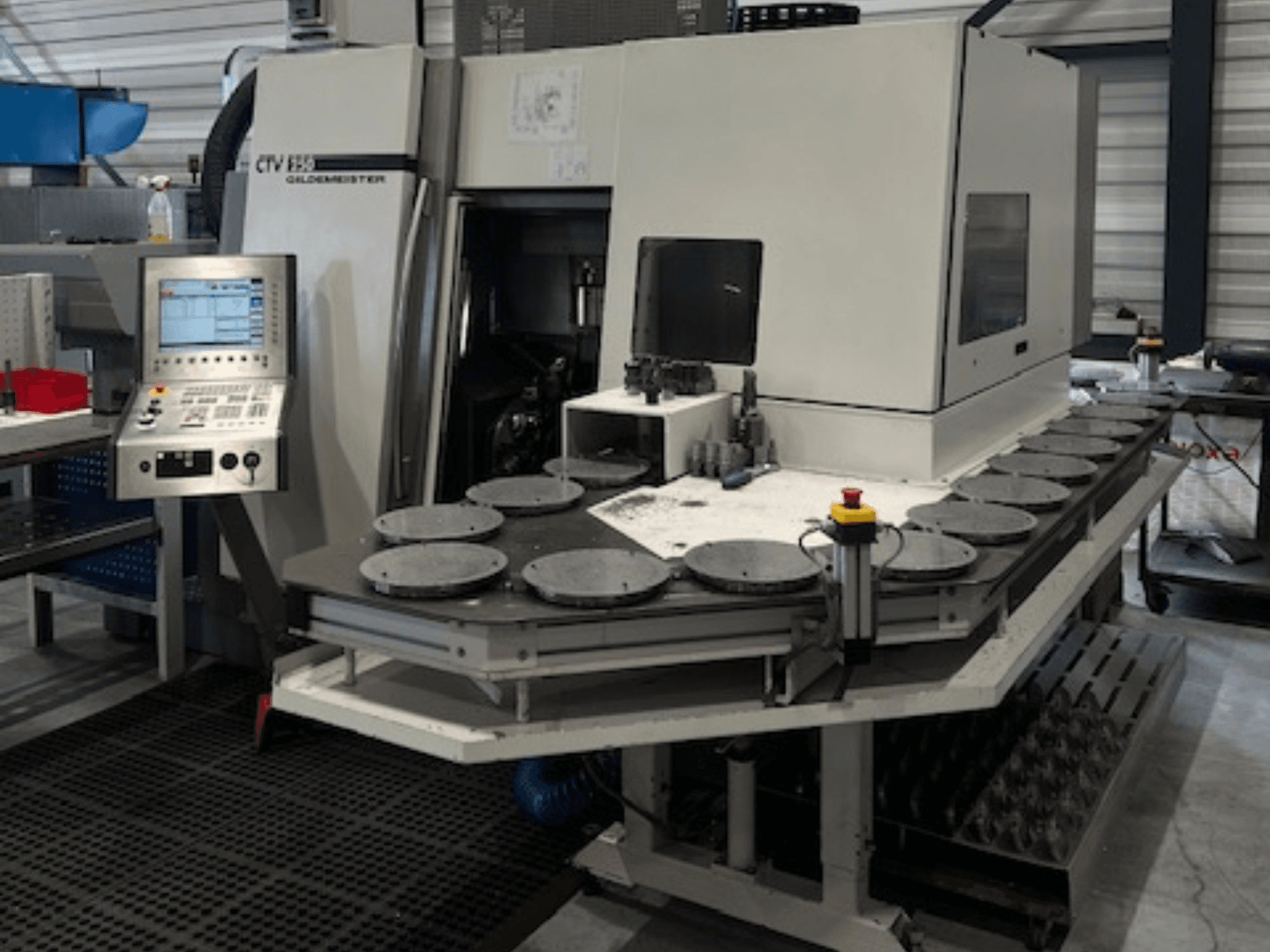 Alt text: CTV E33 Goldmeister machining unit in a workshop, front view, with control panel and multiple circular work platforms.